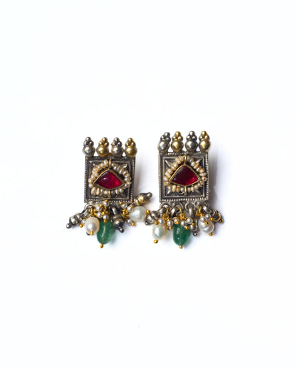 Square framed fusion silver stud earrings in 925 silver with deep red stone, pearl detailing, oxidised finish, and subtle gold-polished accents.