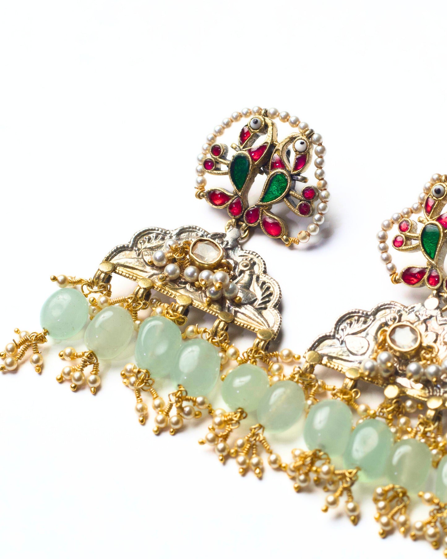 Handcrafted fusion silver earrings with bird detailing, pearl fringes, and soft green stone drops in 925 silver