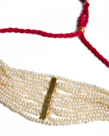 Multi-strand pearl choker in 925 silver featuring a vertical ruby-toned stone bar centre detail