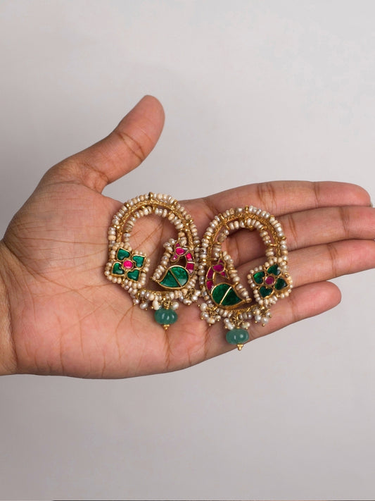 Close-up of Baagh Ke Jhoomar Jhumke in 92.5 silver with meenakari floral motifs, pearls, and green gemstone bead
