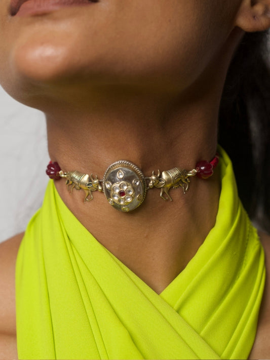 92.5 silver choker with kundan center, twin bull motifs, and red bead accents worn on neck