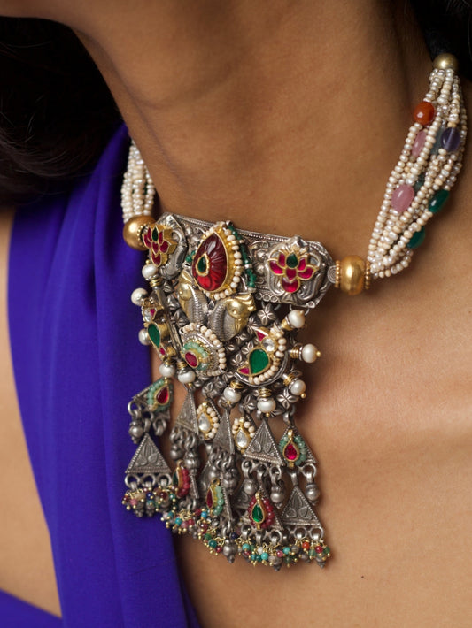 Close-up of She Who Embellishes silver choker necklace featuring kundan work, pearl strands, gold accents, and temple-style motifs from Naksa.