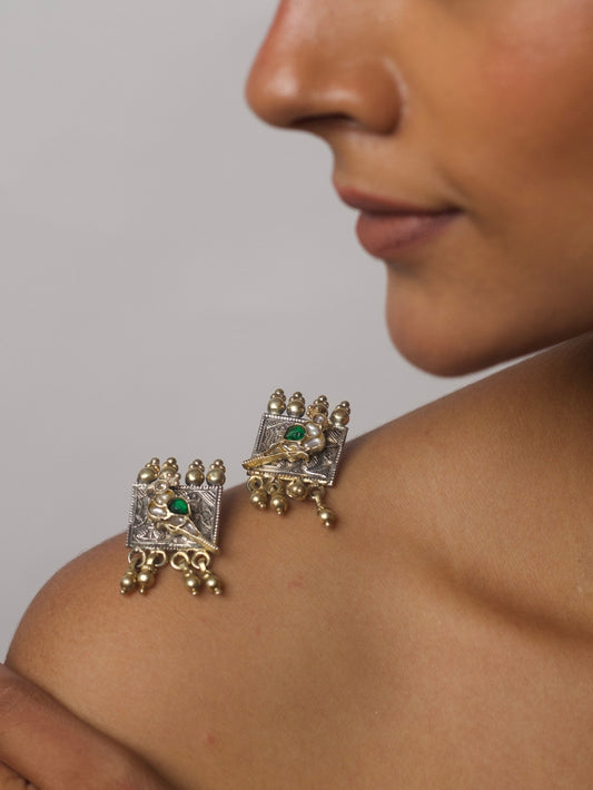 Close-up of Crowned Perch Earrings in pure 92.5 silver featuring parrots perched on a Ganesh-Lakshmi base with kundan work and ghungroos