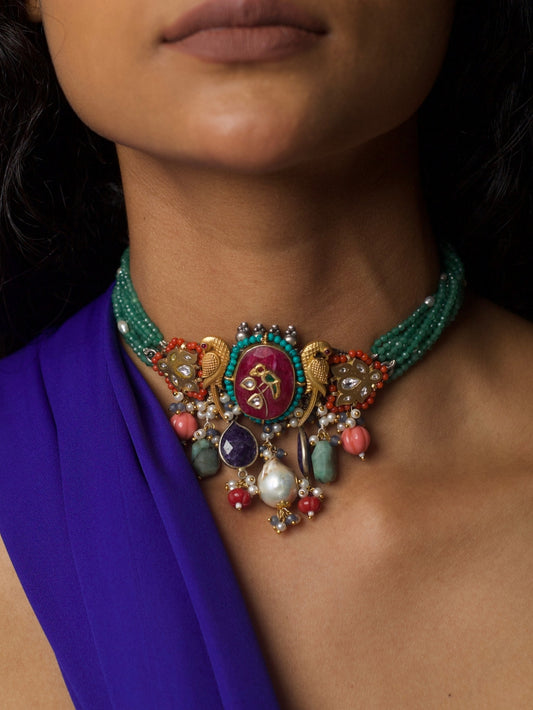 Close-up of Jewel of the Court Choker in 92.5 silver with parrot motifs, carved red center stone, kundan accents, coral and pearl drops