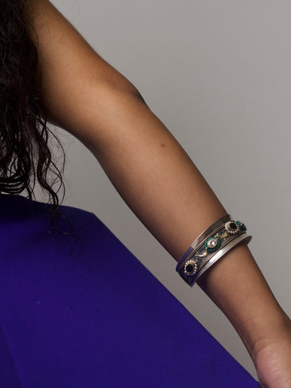 Handcrafted 92.5 silver bracelet with green enamel and tribal detailing, styled on wrist – Naksa Jewelry