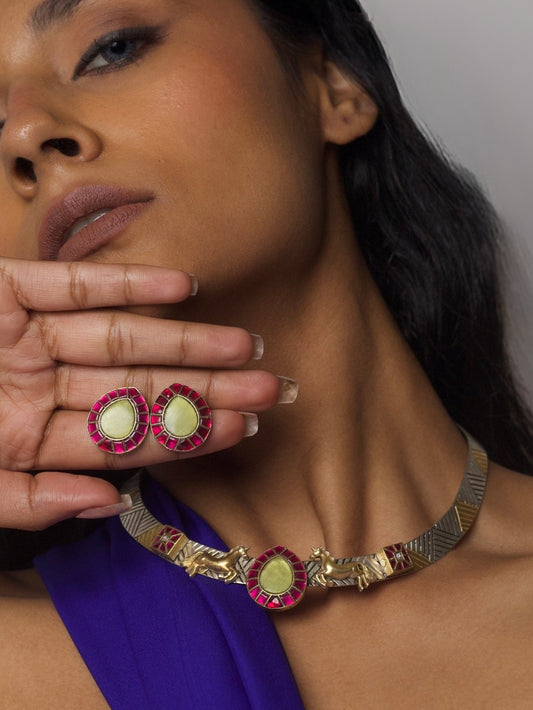 Close-up of The Enchanted Collar Torque Set in pure 92.5 silver featuring red enamel, lemon stone center, and miniature gold dog motifs — styled on model.